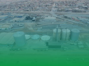 Aerial view of an industrial processing plant and large storage silos in Namibia.